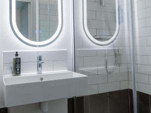 a bathroom with a sink and two mirrors at Ibis Agen Centre - Rénové en 2026 in Agen