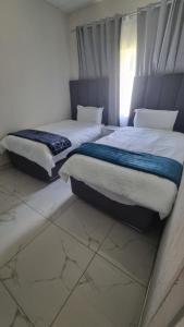 two twin beds in a room with at 124 On Comet Oaks in Boksburg