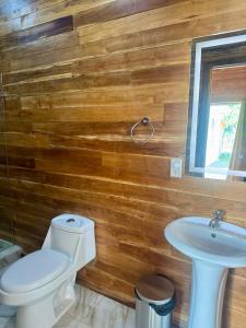 a bathroom with a toilet and a sink at Villa Republik in Parrita +70 photos