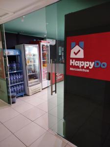 a store with a happy do sign on the wall at Flat Praia Cabo Branco João Pessoa in João Pessoa