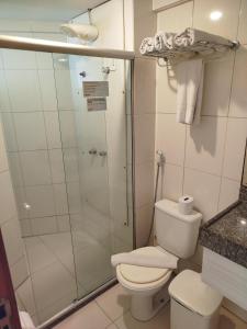 a bathroom with a toilet and a shower at Flat Praia Cabo Branco João Pessoa in João Pessoa
