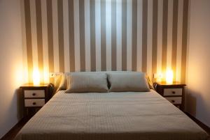 Un dormitorio con una cama con dos mesitas de noche y dos lámparas. en Hostal- Restaurante Estación Vía Verde, en Olvera