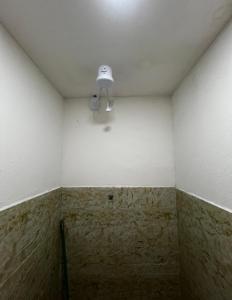 a white room with a light on the ceiling at Studio 94 in Parauapebas