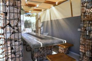 a patio with a stone table and benches at Orion Eco Suites in Karteros