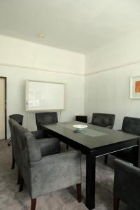 a conference room with a black table and chairs at Tokaanu Retreat in Turangi +22 photos