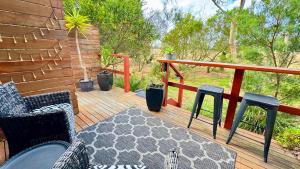 a wooden deck with chairs and a rug on it at Couple's Spa Retreat Resort Villa with complimentary champagne upon arrival in Cowes +70 photos