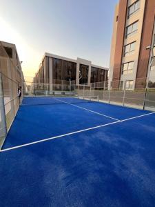 a tennis court in front of a building at Jw Marriott residence in Cairo