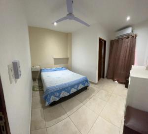 a bedroom with a bed and a ceiling fan at ALOJAMIENTO NORTE 1 in Santiago del Estero