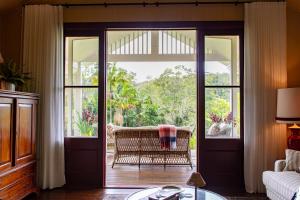 a living room with a door open to a porch at Nightcap Ridge - Byron Bay Hinterland in Dorroughby
