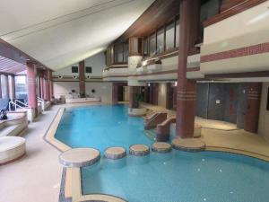 a large swimming pool in a large building at Harbour View in Millom