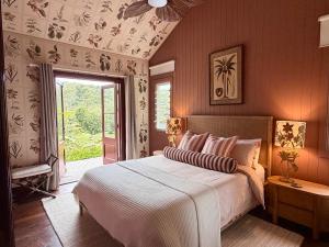 a bedroom with a large bed and a window at Nightcap Ridge - Byron Bay Hinterland in Dorroughby