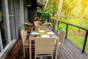 a table and chairs on the porch of a house at Coco forest camping in Kurunegala