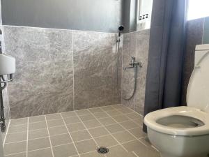 a bathroom with a shower and a toilet at House 1956 in Itoman