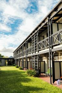 a building with a green lawn in front of it at Tokaanu Retreat in Turangi