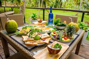 a table with plates of food on top of it at Coco forest camping in Kurunegala +10 photos