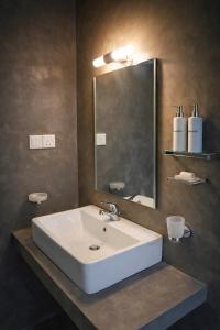 a bathroom with a white sink and a mirror at Coco forest camping in Kurunegala
