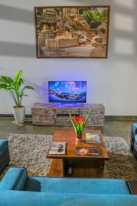 a living room with a blue couch and a table at Coco forest camping in Kurunegala