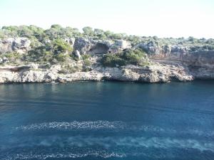 
a large body of water with mountains at Hotel Villa Sirena in Cala Figuera
