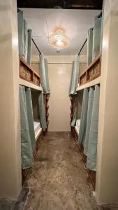 a room with bunk beds and a chandelier at Ginhawa Stay Mixed dorm 6 Bed in Burgos