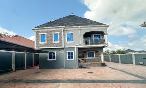 a house with a balcony on top of it at Engeemos Bookastay Apartments in Abeokuta