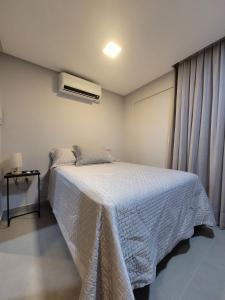 a bedroom with a white bed and a window at Way Bossa by Solis in João Pessoa
