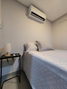 a bedroom with a bed and a air conditioner on the wall at Way Bossa by Solis in João Pessoa