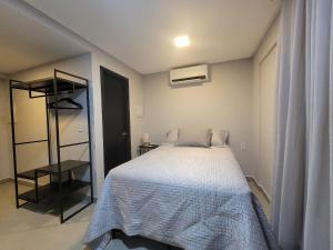 a bedroom with a bed with a white comforter at Way Bossa by Solis in João Pessoa +71 photos