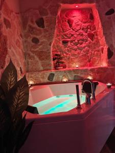 a bathroom with a bath tub with a red lighting at Elysia Luxury Room con Jacuzzi - Centro Brindisi in Brindisi +24 photos