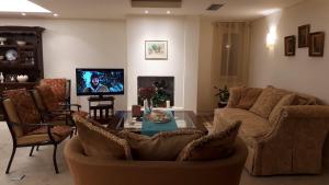 a living room with a couch and a table at Lagonisi Beach Villa in Lagonissi