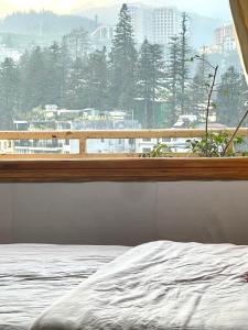 a bedroom with a window with a view of a city at SUN Homestay sa pa in Sapa
