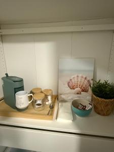 a counter with a tray with a coffee mug and other items at Eastside Costa Mesa Residence in Costa Mesa