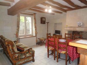 a living room with a table and chairs and a window at Maison tourangelle restaurée, 3 chambres, jardin clos, village viticole, proche loisirs et équipements bébé - FR-1-381-236 in Restigné