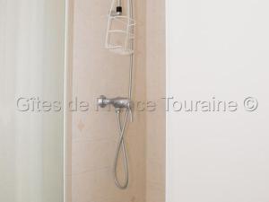 a shower with a shower head in a bathroom at Maison tourangelle restaurée, 3 chambres, jardin clos, village viticole, proche loisirs et équipements bébé - FR-1-381-236 in Restigné +15 photos
