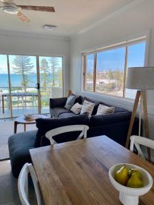 a living room with a couch and a table at Alex Seaside Resort in Alexandra Headland