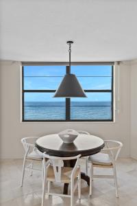 a dining room with a table and a view of the ocean at Privateer #601 in Longboat Key