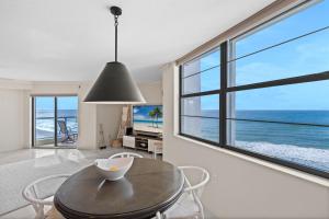 a dining room with a table and a view of the ocean at Privateer #601 in Longboat Key
