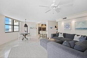 a living room with a couch and a dining room at Privateer #601 in Longboat Key