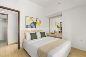 a bedroom with a large white bed and a mirror at Elion by Kozystay - BSD in Samporo +29 photos