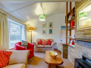 a living room with two couches and a fireplace at Hall Farm Bungalow in Shirley