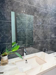 a bathroom with a sink and a mirror at Lúa Vàng homestay in Pleiku Airport +76 photos