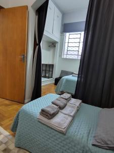a bedroom with two beds with towels on them at Loft Cruzeiro in Belo Horizonte