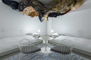 a living room with a table and a couch at BnA Alter Museum in Kyoto