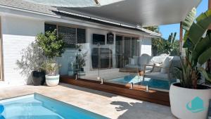 a house with a swimming pool and a patio at Summerland Escape in Summerland Point
