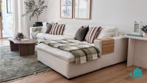 a white living room with a couch and a table at Summerland Escape in Summerland Point +17 photos