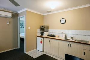 a kitchen with a refrigerator and a clock on the wall at Grandis 35 in Albany