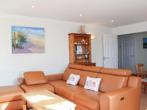 a living room with a couch and a table at 3 Thurlestone Rock in Kingsbridge
