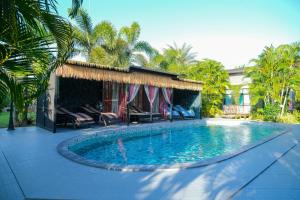 a swimming pool in the middle of a yard at The Longhouse Luxury Boutique Resort in Sakon Nakhon