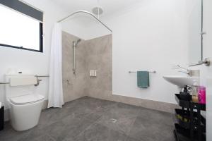 a bathroom with a shower and a toilet and a sink at Winchester Residence in Armadale +15 photos