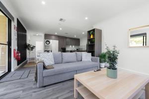a living room with a couch and a table at Winchester Residence in Armadale