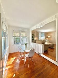 a living room with a table and chairs and a bed at North Haven Rooms in North Haven